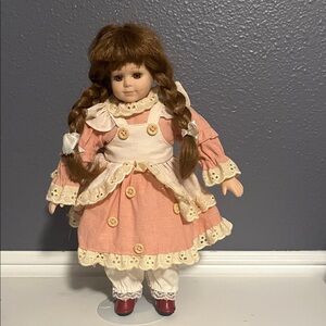 Porcelain Doll with Pink Dress and Braided Hair. Geppetto button girl.